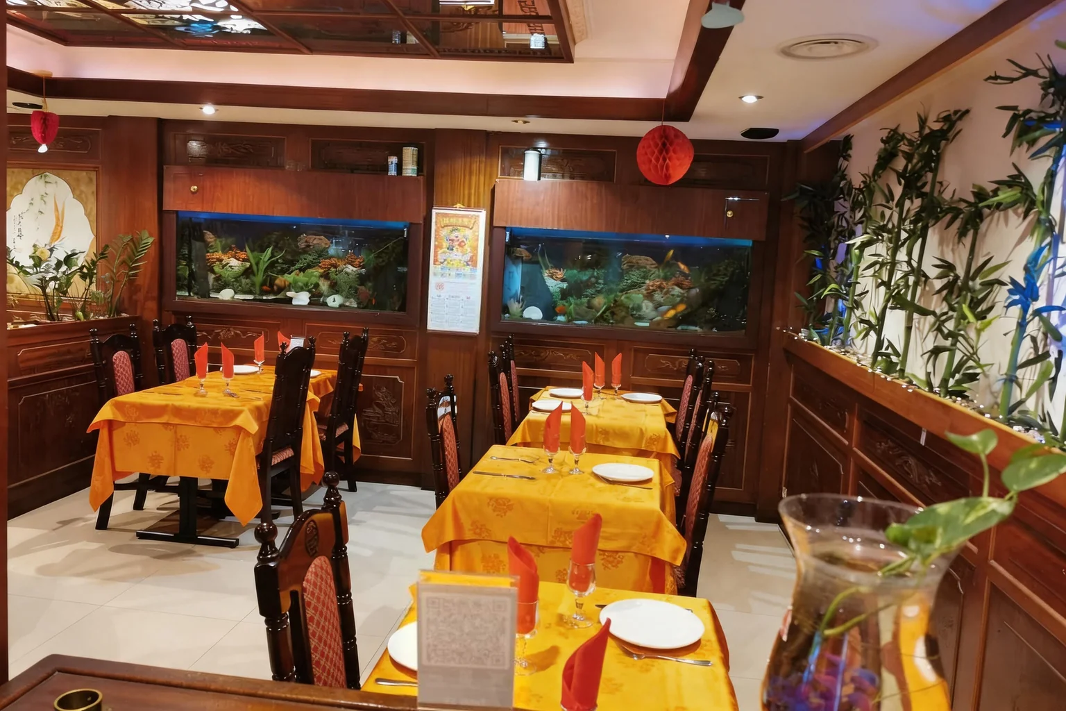 The dining room: two aquariums, orange tablecloths, red lanterns
